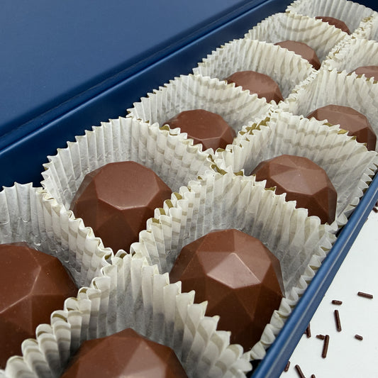Chocolate Asscher and Brilliant Truffles in white paper cups inside a blue box