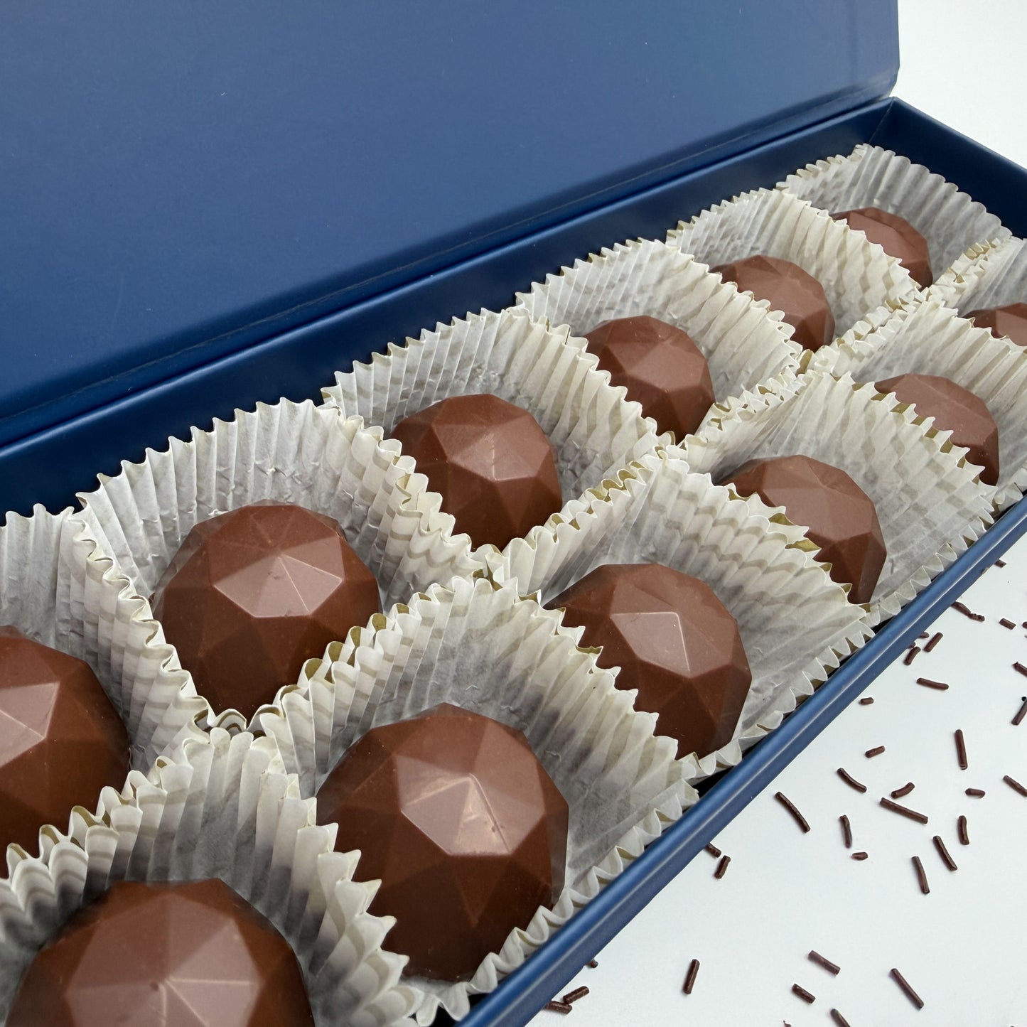 Chocolate Brilliants in white wrappers inside a blue box
